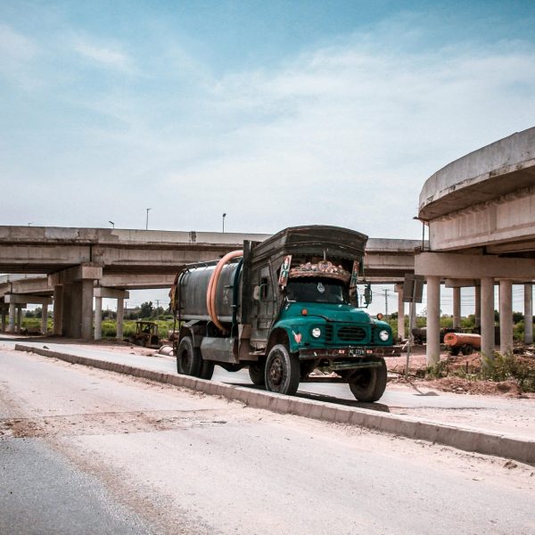 Tanker truck and vehicles on a highway in Kotri, Sindh, Pakistan. Urban transportation system.