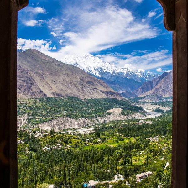 Breathtaking view of Hunza Valley and mountains framed by Altit Fort architecture.